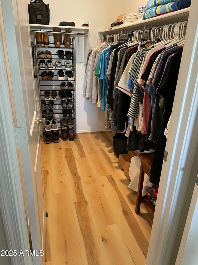 spacious closet featuring hardwood / wood-style floors