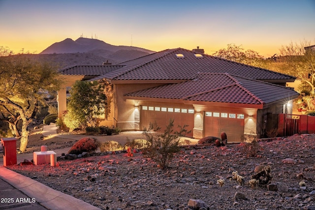 view of front facade with a mountain view and a garage