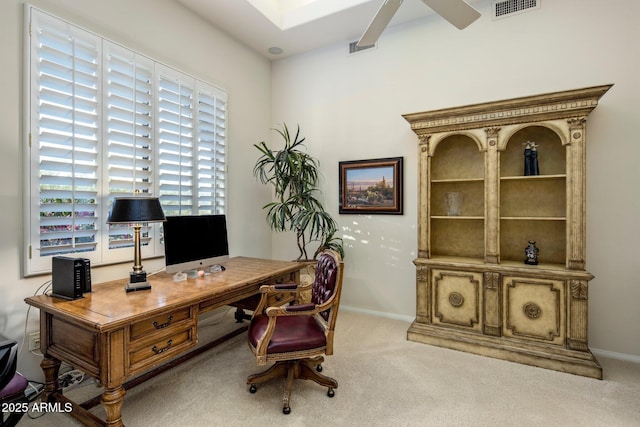 carpeted home office with ceiling fan