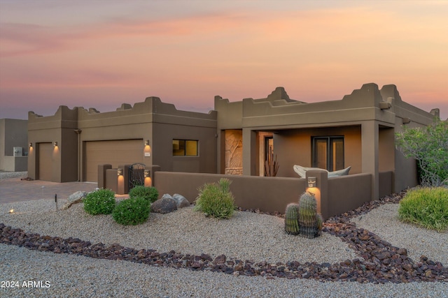 pueblo-style house with a garage