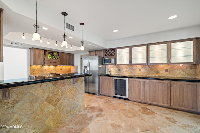 kitchen featuring pendant lighting, backsplash, stainless steel appliances, wine cooler, and a raised ceiling