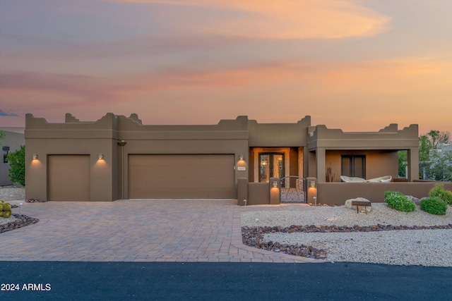 pueblo-style home with a garage