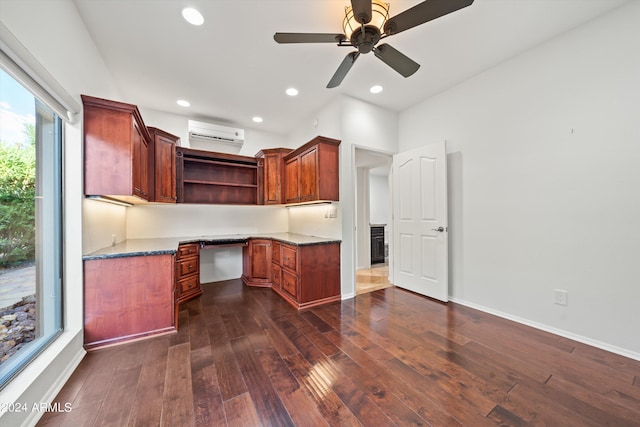 kitchen with a wall mounted air conditioner, dark wood-type flooring, built in desk, and ceiling fan