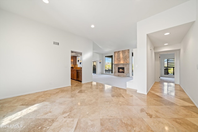 unfurnished living room featuring a large fireplace