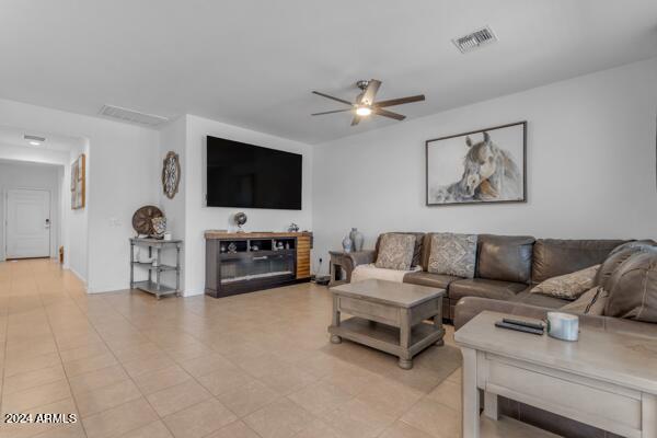 living room featuring light tile patterned floors and ceiling fan