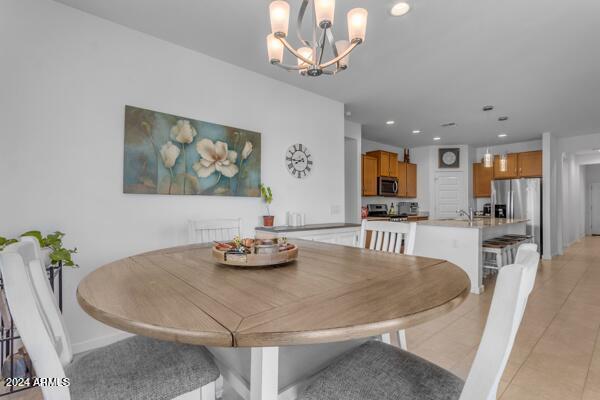 dining room with a chandelier and light tile patterned flooring