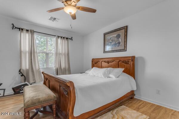 bedroom with ceiling fan and light hardwood / wood-style floors