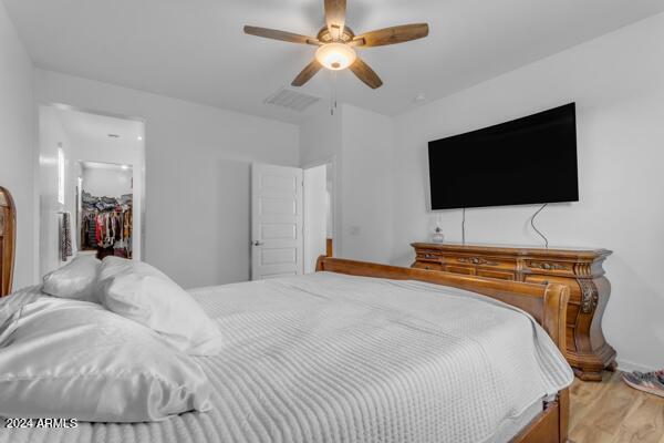 bedroom with ceiling fan, a closet, and light wood-type flooring