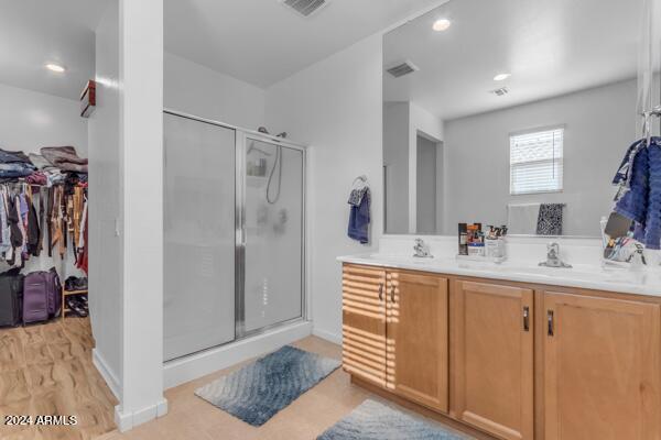 bathroom featuring vanity, wood-type flooring, and an enclosed shower