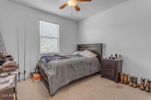 carpeted bedroom with ceiling fan