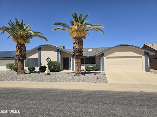 view of front facade featuring an attached garage, stucco siding, and concrete driveway