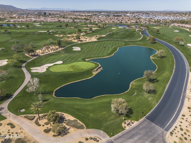 aerial view with golf course view and a water and mountain view