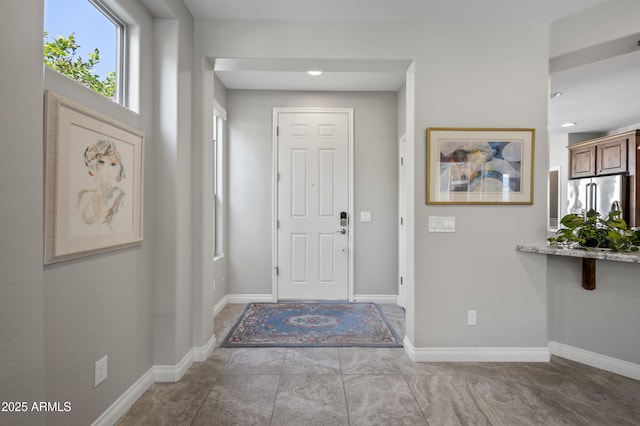 foyer featuring baseboards