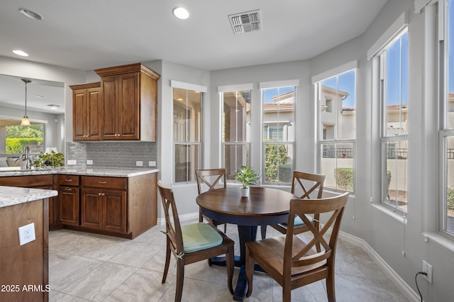 dining space featuring light tile patterned flooring, baseboards, and visible vents