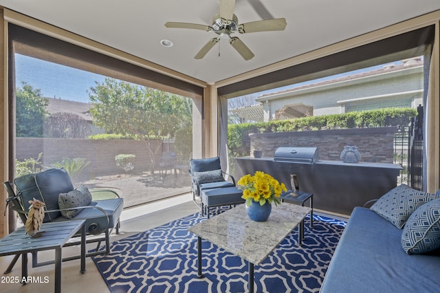 sunroom featuring ceiling fan