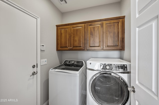 laundry room featuring cabinet space, washing machine and dryer, and visible vents