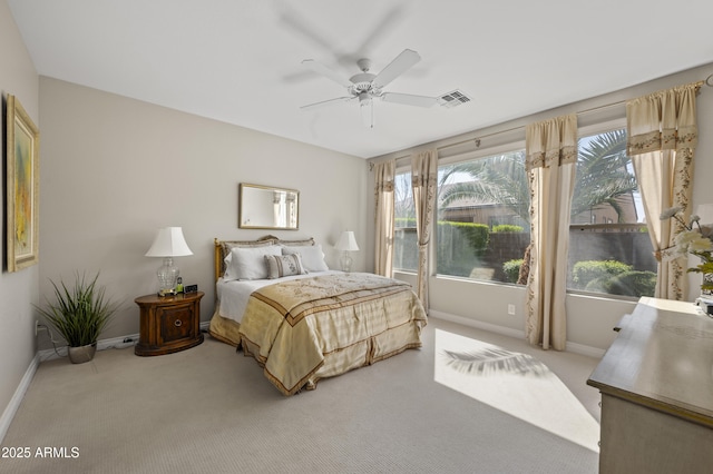 bedroom with visible vents, light carpet, baseboards, and ceiling fan