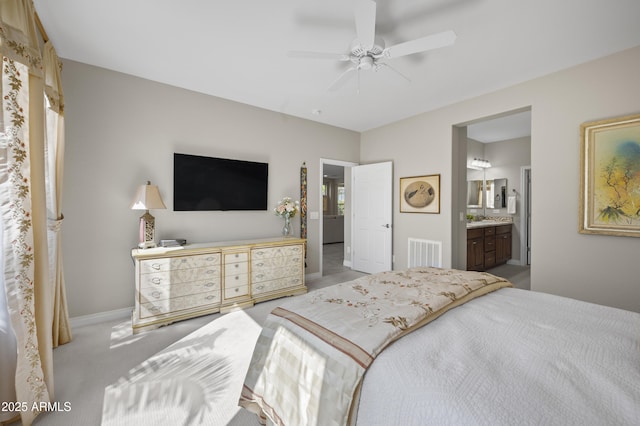 carpeted bedroom with ceiling fan, baseboards, visible vents, and connected bathroom