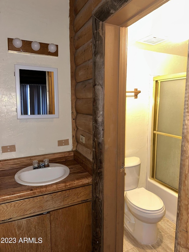 full bathroom with shower / bath combination with glass door, toilet, and vanity