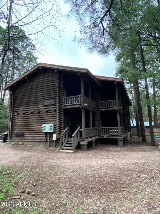 rear view of house featuring a balcony