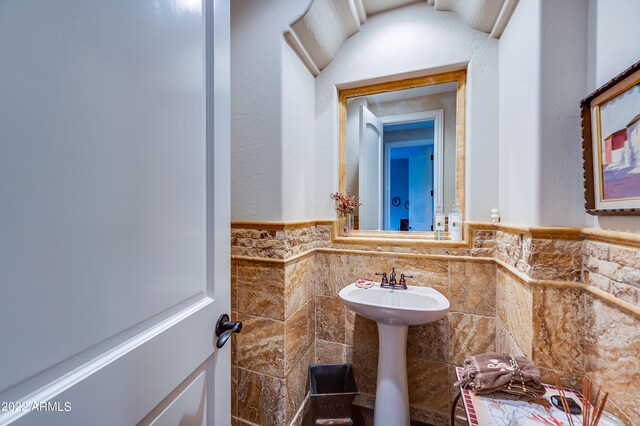 bathroom with tile walls and sink