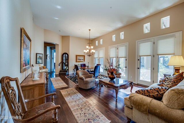 living room with dark hardwood / wood-style floors and a chandelier