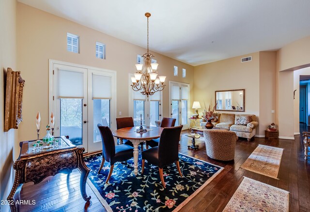 dining room featuring a notable chandelier, dark hardwood / wood-style floors, and french doors