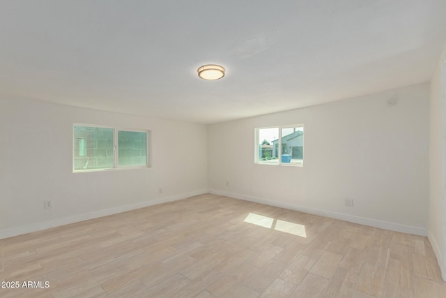 spare room featuring light hardwood / wood-style flooring