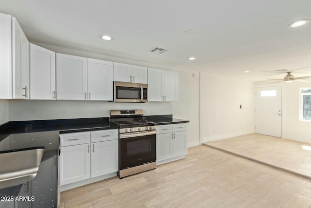 kitchen with white cabinets, stainless steel appliances, and ceiling fan