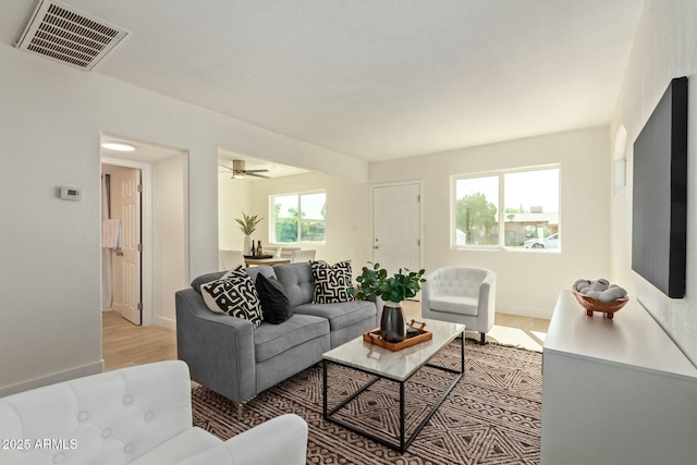 living room featuring light hardwood / wood-style floors, plenty of natural light, and ceiling fan