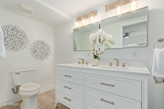 bathroom with ceiling fan, toilet, and vanity