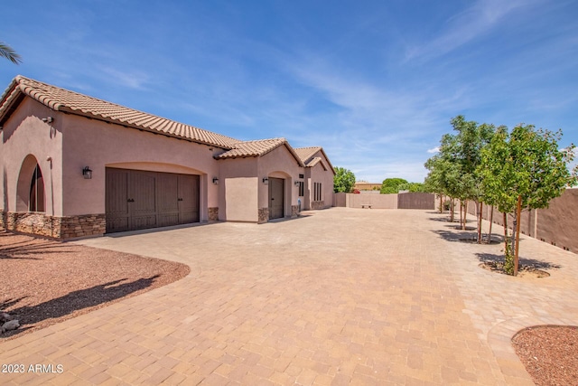 mediterranean / spanish house featuring a garage