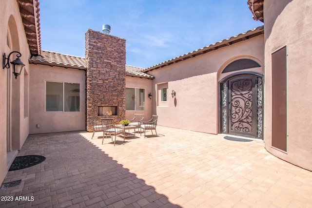 view of patio featuring an outdoor living space with a fireplace