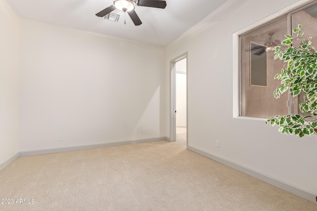 carpeted spare room with ceiling fan