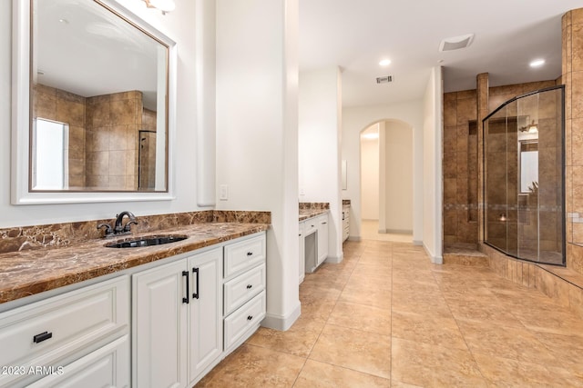 bathroom featuring tile patterned floors, vanity, and an enclosed shower