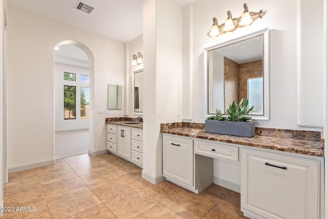 bathroom featuring tile patterned flooring and vanity