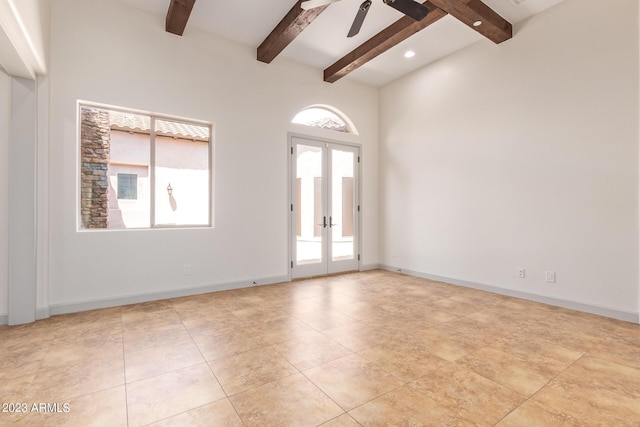 unfurnished room with ceiling fan, beam ceiling, a healthy amount of sunlight, and french doors