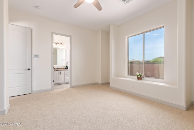 interior space with ceiling fan and light carpet