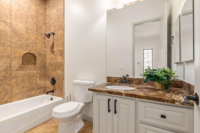 full bathroom with tile patterned flooring, vanity, toilet, and tiled shower / bath combo