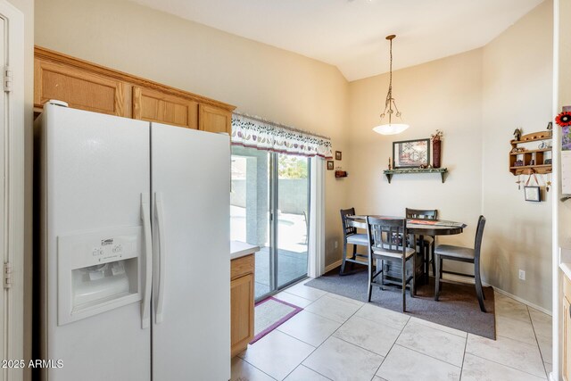 12318 W Bloomfield Rd, El Mirage, AZ 85335 - kitchen with white fridge with ice dispenser, hanging light fixtures, lofted ceiling, light tile patterned flooring, and light countertops