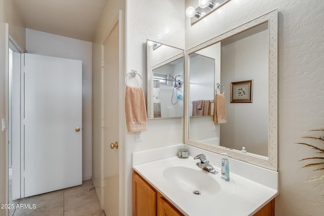 12318 W Bloomfield Rd, El Mirage, AZ 85335 - bathroom with vanity, a textured wall, and tile patterned floors