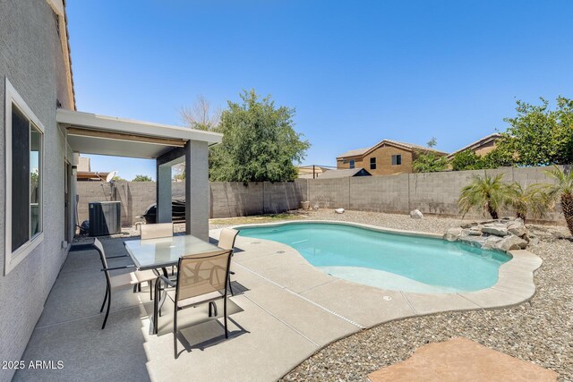 12318 W Bloomfield Rd, El Mirage, AZ 85335 - view of pool with cooling unit, a patio area, a fenced backyard, and outdoor dining space