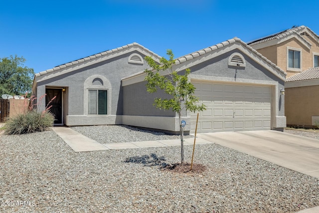 12318 W Bloomfield Rd, El Mirage, AZ 85335 - view of front facade with a garage, concrete driveway, a tile roof, and stucco siding