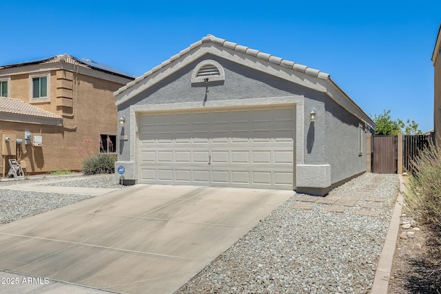 12318 W Bloomfield Rd, El Mirage, AZ 85335 - view of front of house with driveway, a garage, a gate, stucco siding, and a tile roof