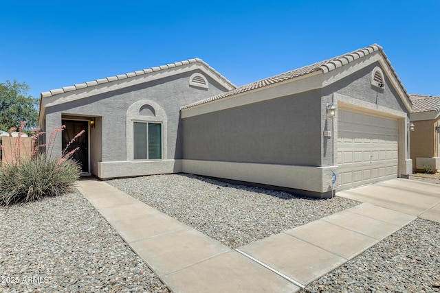 12318 W Bloomfield Rd, El Mirage, AZ 85335 - view of front facade featuring an attached garage, stucco siding, a tiled roof, and driveway