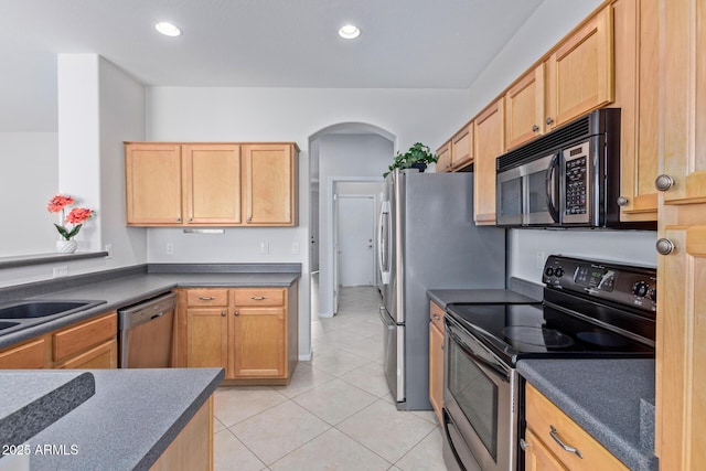 kitchen featuring stainless steel appliances, sink, light tile patterned floors, and light brown cabinets