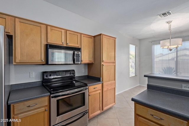 kitchen featuring light tile patterned flooring, appliances with stainless steel finishes, and hanging light fixtures