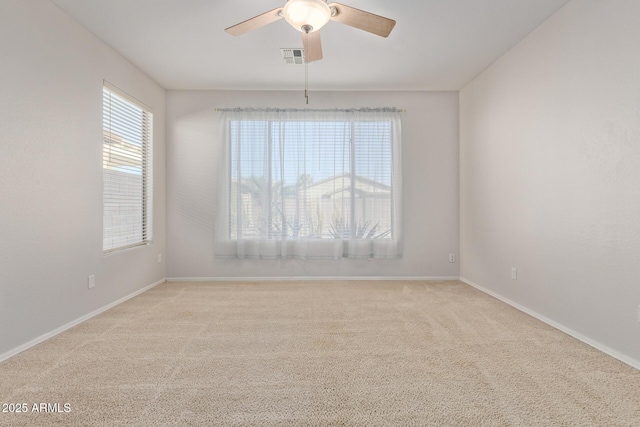 empty room featuring light carpet and ceiling fan