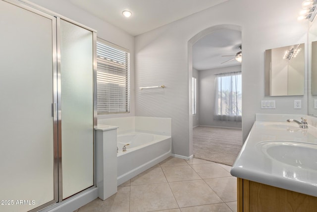 bathroom featuring tile patterned flooring, vanity, ceiling fan, and plus walk in shower