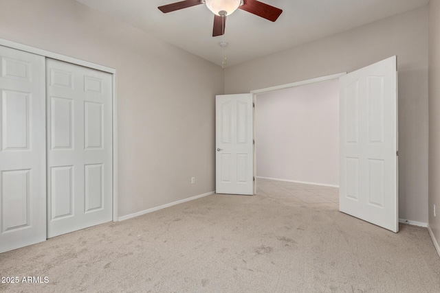 unfurnished bedroom with light colored carpet, ceiling fan, and a closet